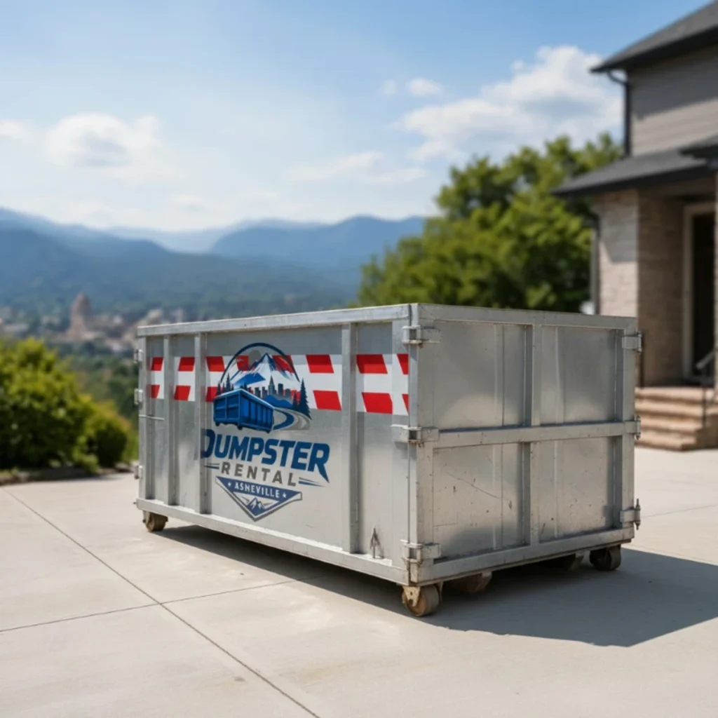 Roll-off dumpster placed on a concrete driveway with mountains behind — dumpster rental serving Brevard, NC